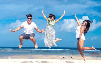 Group of multiracial friends having fun on the beach of tropical Bali island.